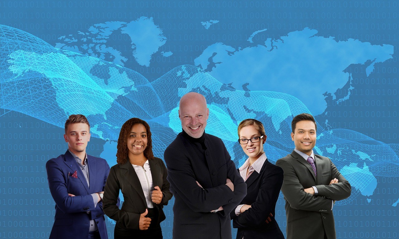 EmeMar global team posing together with world map background